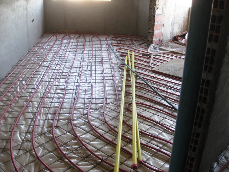 Hydronic radiant floor tubing secured over insulation before the floor pour