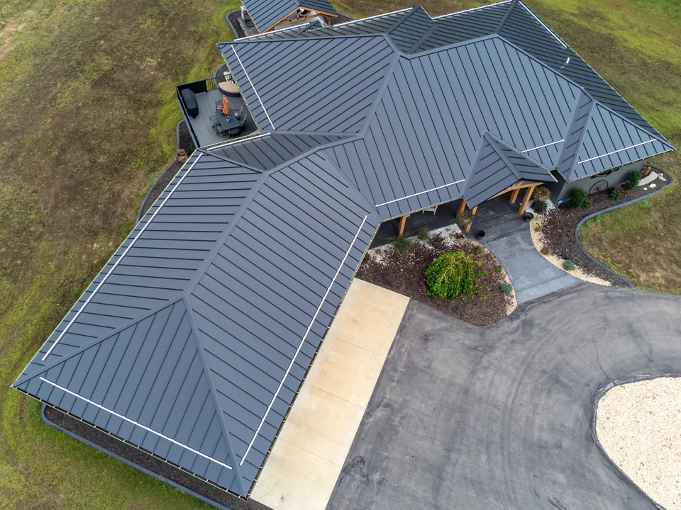 Actual standing-seam metal roof showing concealed fastening and roof transitions